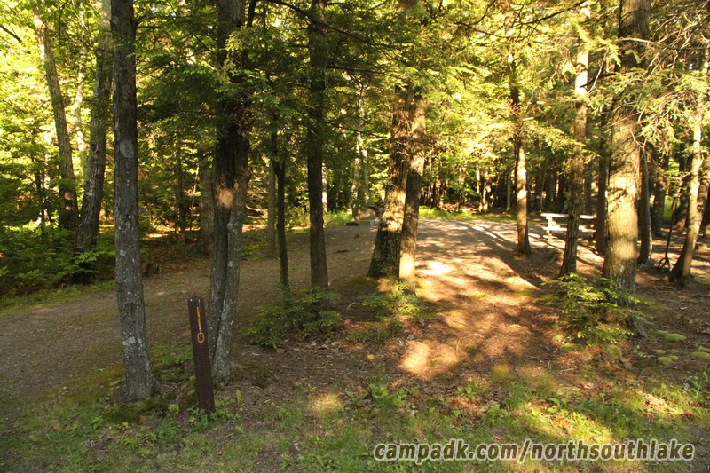 Campsite Photo of Site 110 at North South Lake Campground, New York - Looking at Site from Road Sign Visible