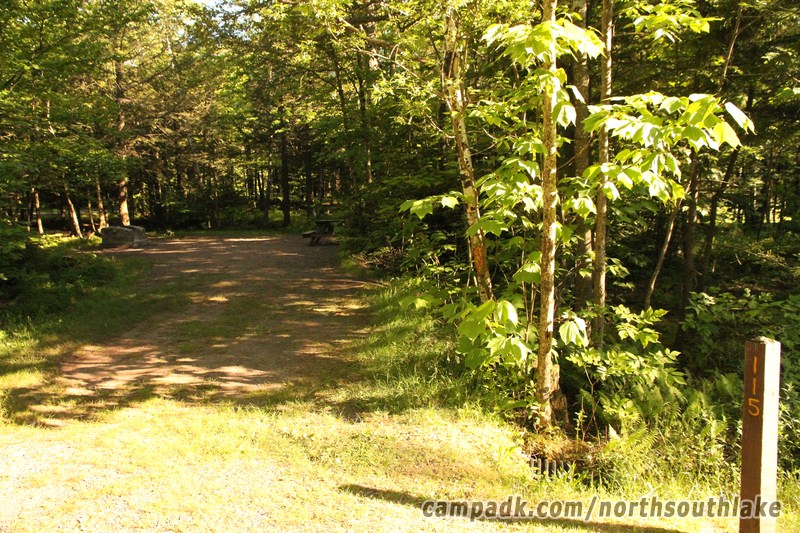 Campsite Photo of Site 115 at North South Lake Campground, New York - Looking at Site from Road Sign Visible