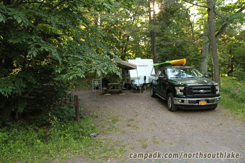 Campsite Photo of Site 140 at North South Lake Campground, New York - Looking at Site from Road Sign Visible