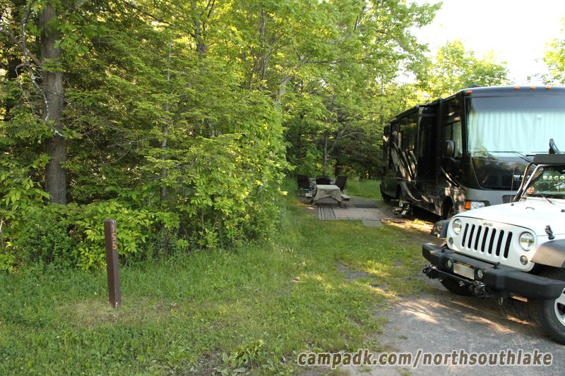 Campsite Photo of Site 155 at North South Lake Campground, New York - Looking at Site from Road Sign Visible