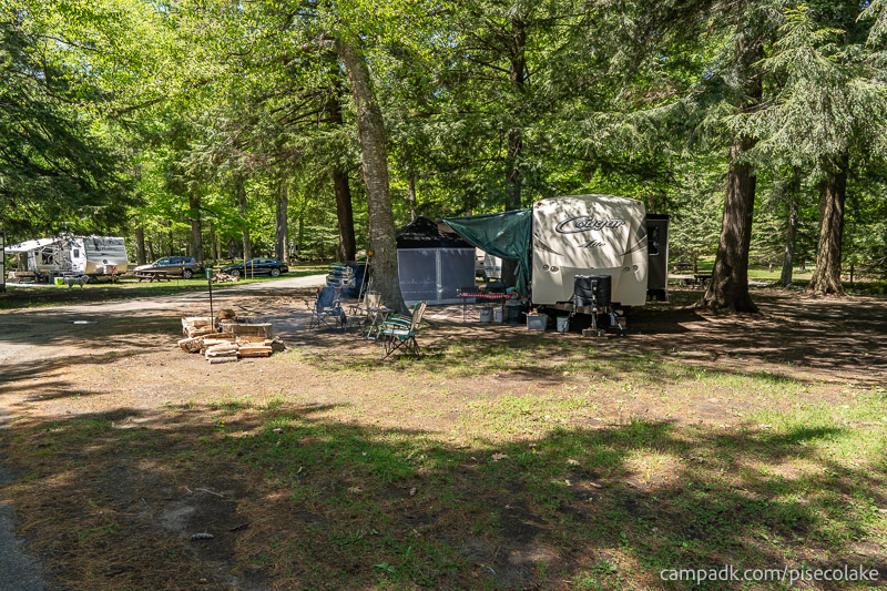 Campsite Photo of Site 83 at Piseco Lake Campground, New York - Looking at Site from Road Sign Visible