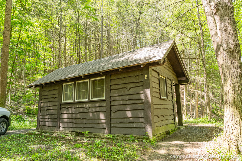 Campsite Photo of Site 8 at Robert H Treman State Park, New York - Looking at Site from Road Sign Visible