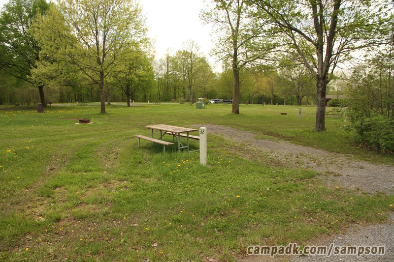 Campsite Photo of Site 32 at Sampson State Park, New York - Looking at Site from Road Sign Visible