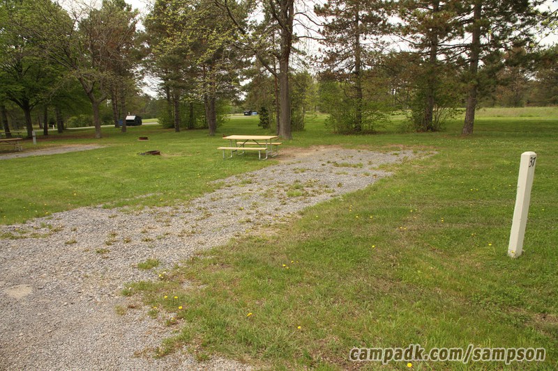 Campsite Photo of Site 37 at Sampson State Park, New York - Looking at Site from Road Sign Visible