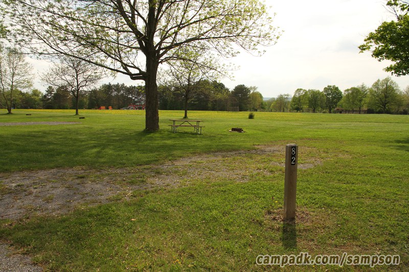 Campsite Photo of Site 82 at Sampson State Park, New York - Looking at Site from Road Sign Visible