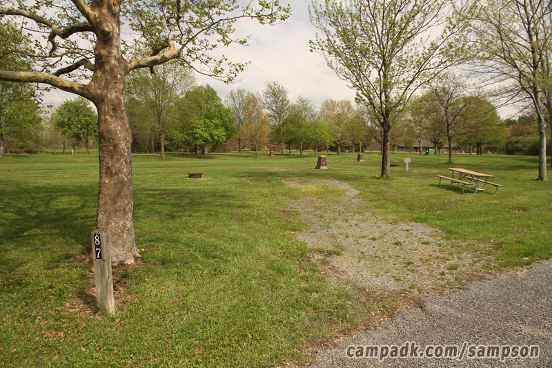 Campsite Photo of Site 87 at Sampson State Park, New York - Looking at Site from Road Sign Visible