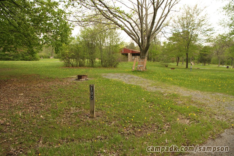 Campsite Photo of Site 107 at Sampson State Park, New York - Looking at Site from Road Sign Visible