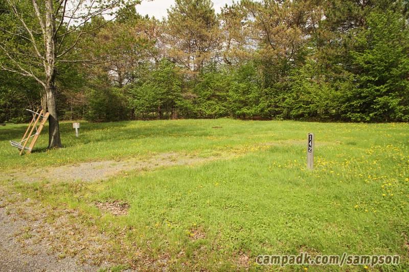 Campsite Photo of Site 142 at Sampson State Park, New York - Looking at Site from Road Sign Visible