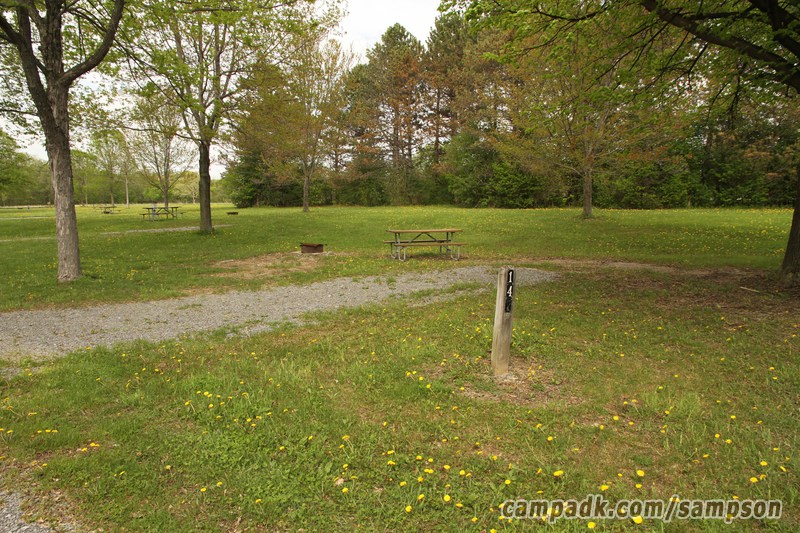 Campsite Photo of Site 147 at Sampson State Park, New York - Looking at Site from Road Sign Visible