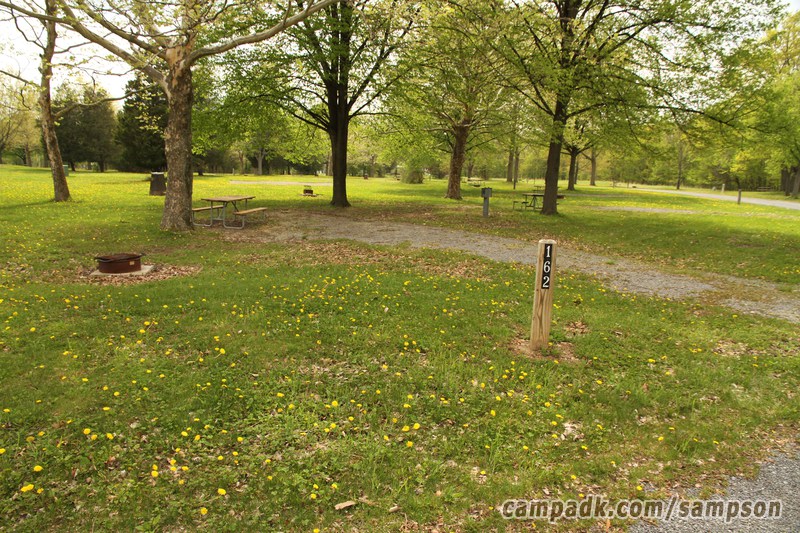Campsite Photo of Site 162 at Sampson State Park, New York - Looking at Site from Road Sign Visible