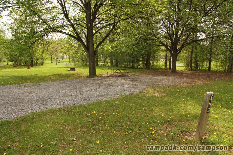 Campsite Photo of Site 182 at Sampson State Park, New York - Looking at Site from Road Sign Visible