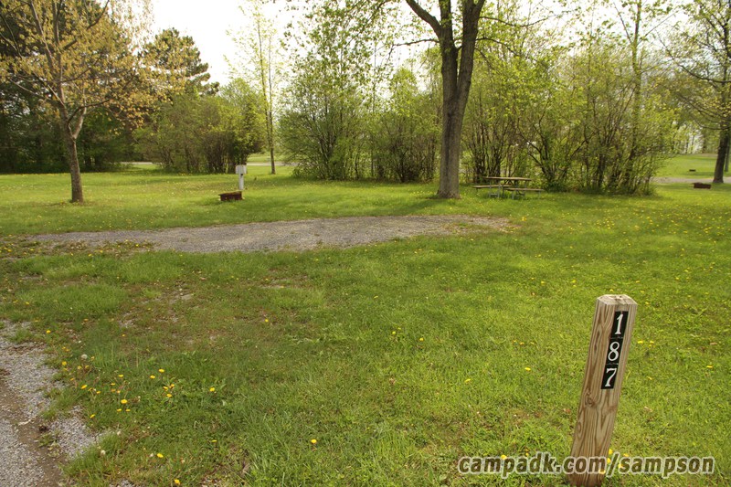 Campsite Photo of Site 187 at Sampson State Park, New York - Looking at Site from Road Sign Visible