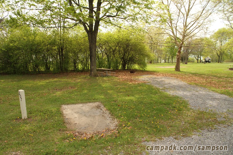Campsite Photo of Site 207 at Sampson State Park, New York - Looking at Site from Road Sign Visible