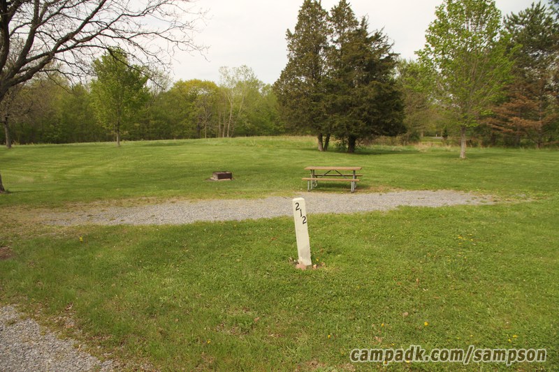 Campsite Photo of Site 212 at Sampson State Park, New York - Looking at Site from Road Sign Visible