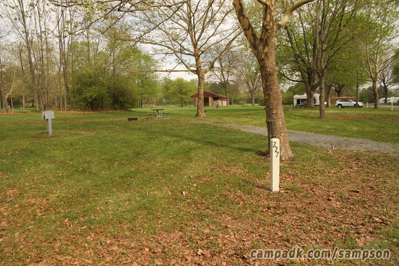 Campsite Photo of Site 227 at Sampson State Park, New York - Looking at Site from Road Sign Visible