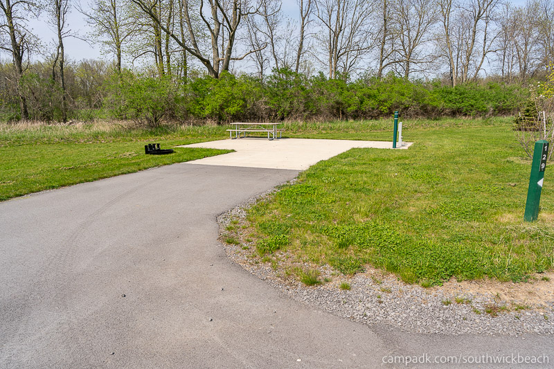 Campsite Photo of Site 129 at Southwick Beach State Park, New York - Looking at Site from Road Sign Visible